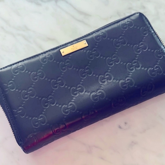 Gucci Handbags - Gucci Black Embossed Leather Zip Wallet